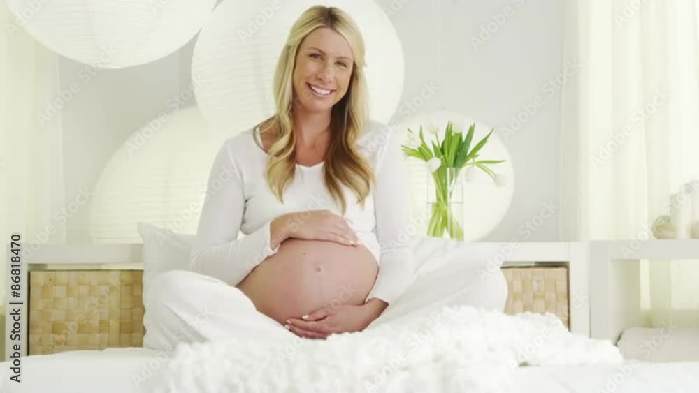 Beautiful pregnant woman smiling and holding belly Beautiful pregnant woman smiling and holding belly