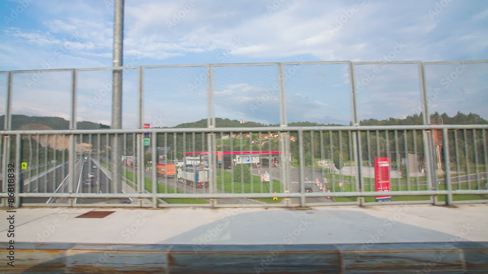 Driving slow motion on bridge with highway under Driving slow motion on bridge with highway under