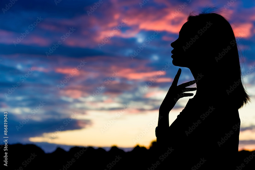 silhouette of beautiful sexy woman on the background of sunset
