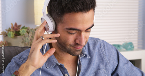 Handsome Mexican guy listening to music