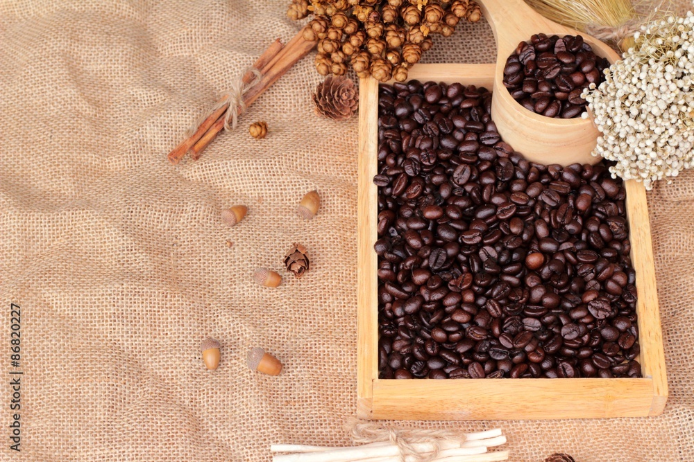 Roasted coffee beans on sack brown background. Roasted coffee beans on sack brown background.
