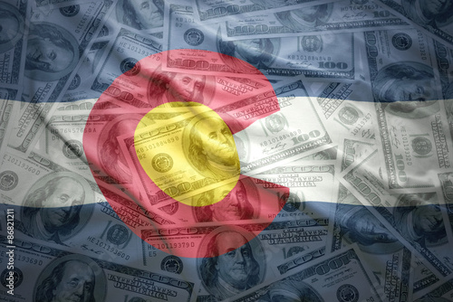 colorful waving colorado state flag on a american dollar money background