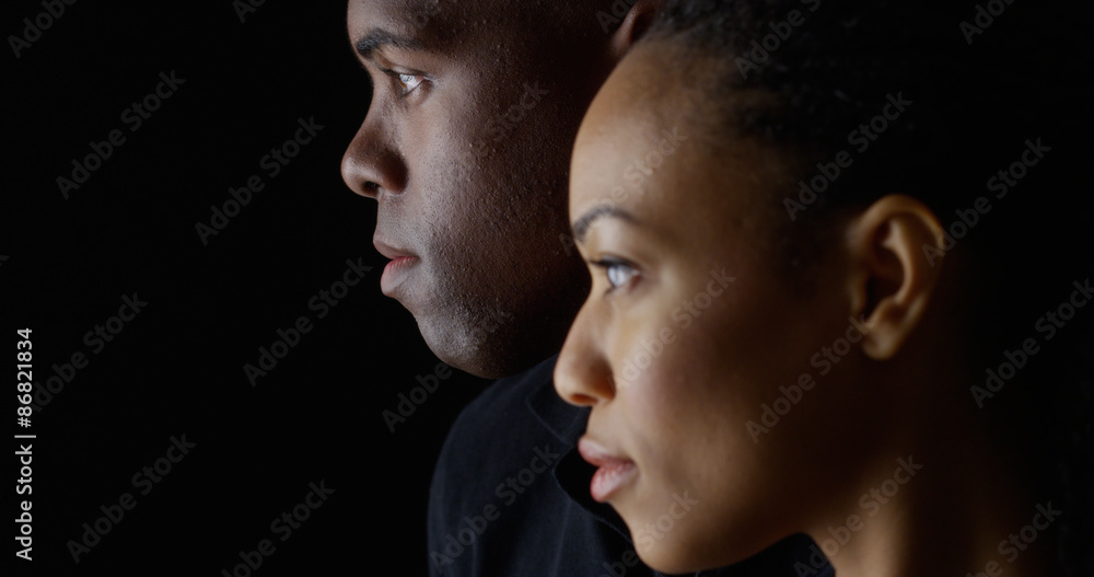 Dramatic profile rack focus of two young black people Dramatic profile rack focus of two young black people