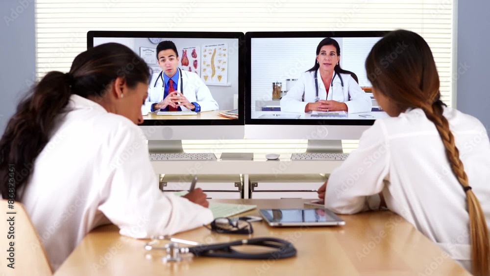 Multi-ethnic team of medical doctors having a video conference Multi-ethnic team of medical doctors having a video conference