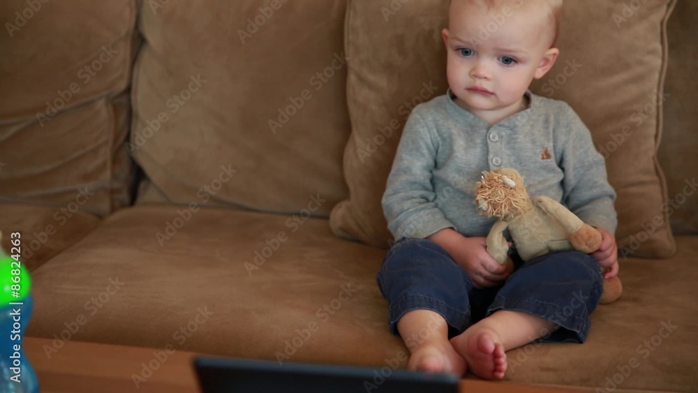 cute toddler boy watching a movie on a tablet cute toddler boy watching a movie on a tablet