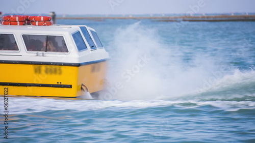 Ship back while speeding on sea photo