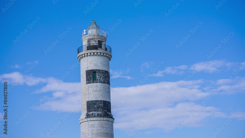Driving around lighthouse under blue sky Driving around lighthouse under blue sky
