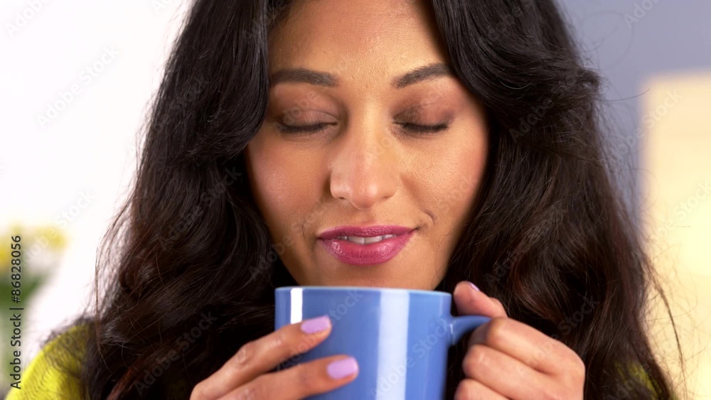 Happy Mexican woman holding mug Happy Mexican woman holding mug