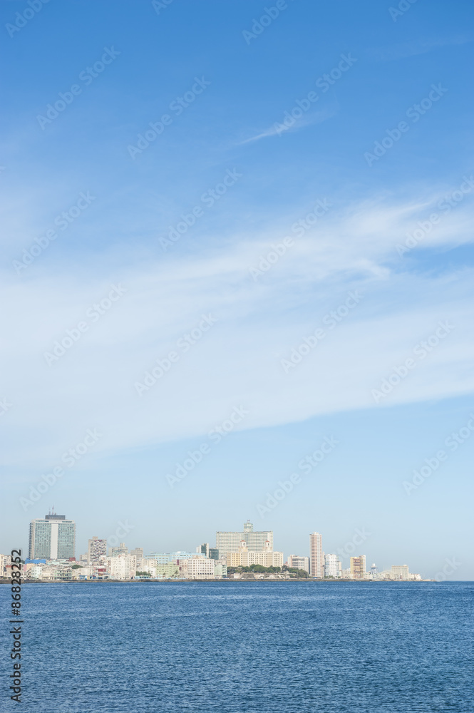 Havana Cuba daytime skyline along the Malecon waterfront with the Caribbean Sea under bright blue sky
