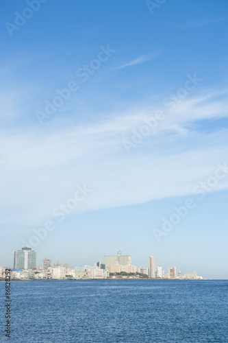 Havana Cuba daytime skyline along the Malecon waterfront with the Caribbean Sea under bright blue sky © lazyllama