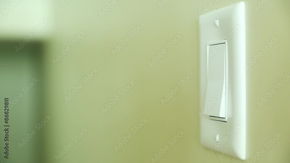 hand turning on and off a light switch