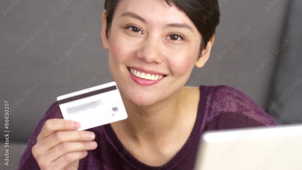 Attractive Asian woman holding credit card Attractive Asian woman holding credit card