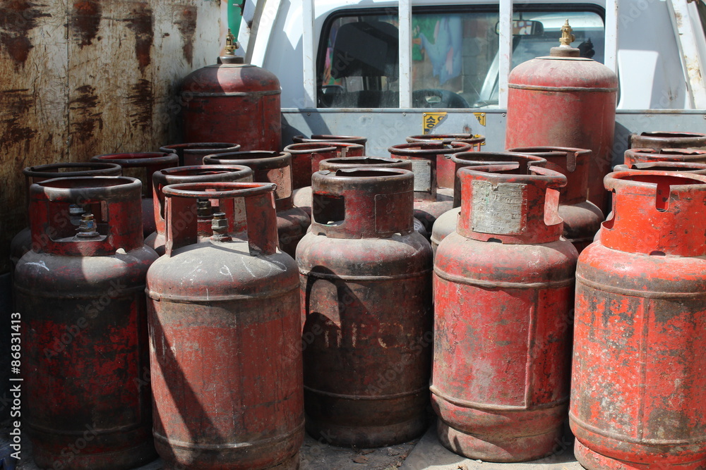 Old red gas cylinders.
High pressure propane or LPG gas cylinders.