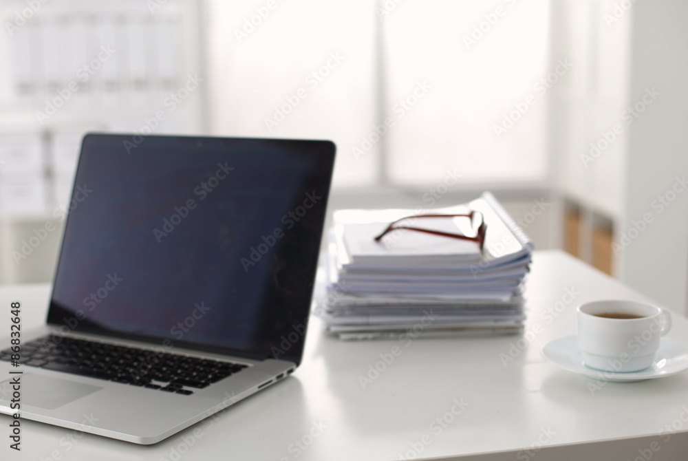 newspaper,eyeglasses, cup and laptop newspaper,eyeglasses, cup and laptop