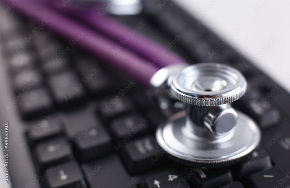 Violet stethoscope on a laptop computer Violet stethoscope on a laptop computer