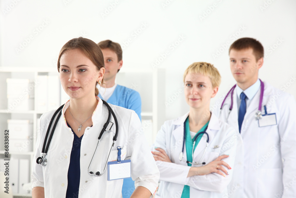 Medical team smiling at camera together at the hospital Medical team smiling at camera together at the hospital