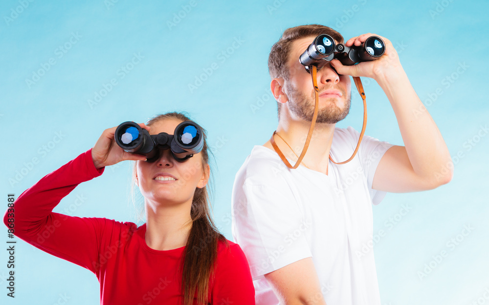 Couple looking through binoculars Couple looking through binoculars