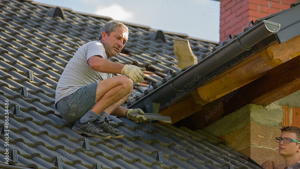 Man Throwing Away Broken Roof Tiles After Hail Storm Man Throwing Away Broken Roof Tiles After Hail Storm