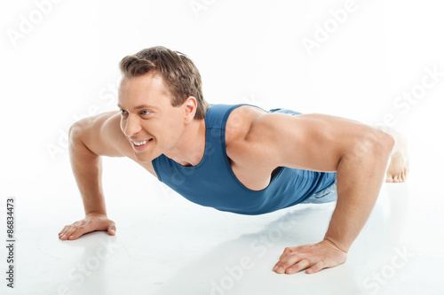 Attractive young healthy sportsman is doing push-ups
