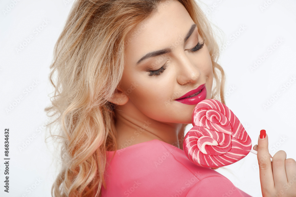 Attractive healthy woman with sweet pink candy Attractive healthy woman with sweet pink candy