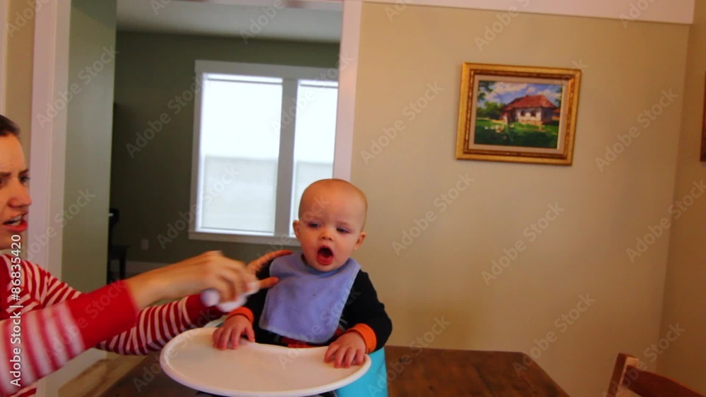 A mother wiping her babies mouth 2 A mother wiping her babies mouth 2
