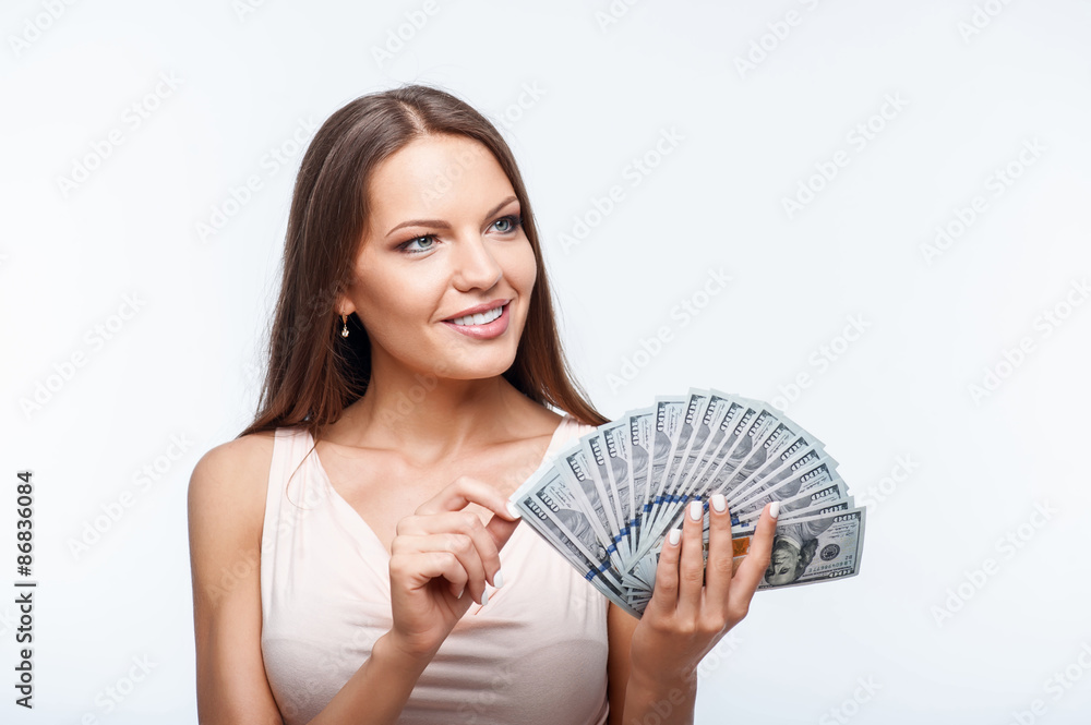 Cheerful young girl with pretty smile has dollars Cheerful young girl with pretty smile has dollars