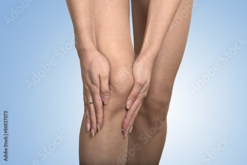 cropped image woman hands touching painful leg knee