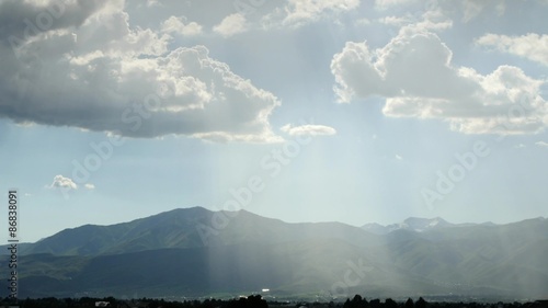 Timelapse beautiful rays of sun over mountain range photo