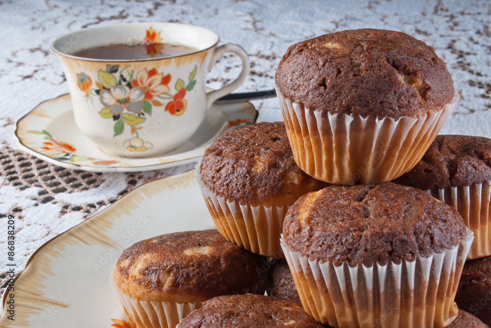 Classical tea time with tasty muffins over retro ambient with porcelain dishes. Classical tea time with tasty muffins over retro ambient with porcelain dishes.