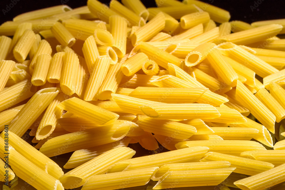 Heap of macaroni noodles reflecting on black background Heap of macaroni noodles reflecting on black background