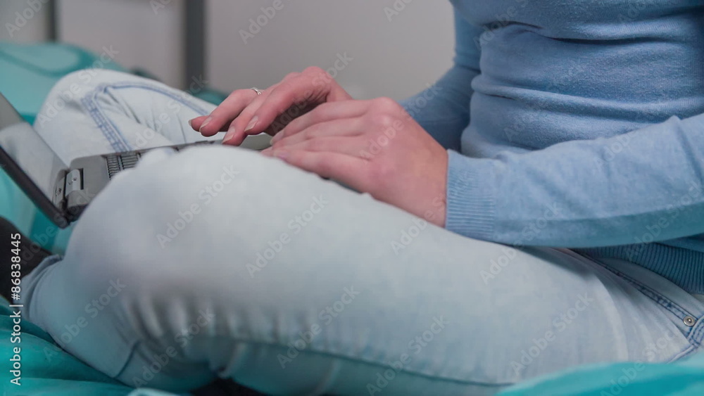 Person working on computer while on bed Person working on computer while on bed