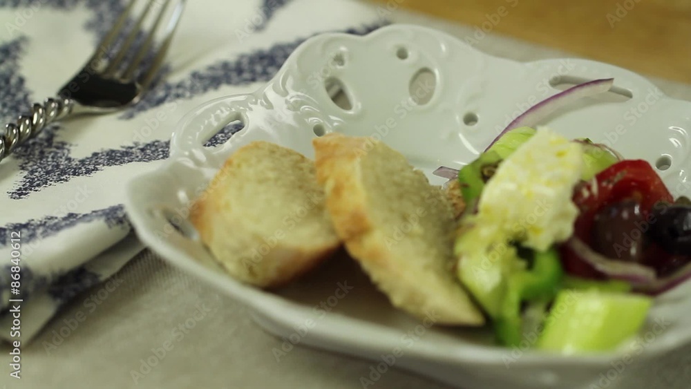 placing a greek salad on the table placing a greek salad on the table