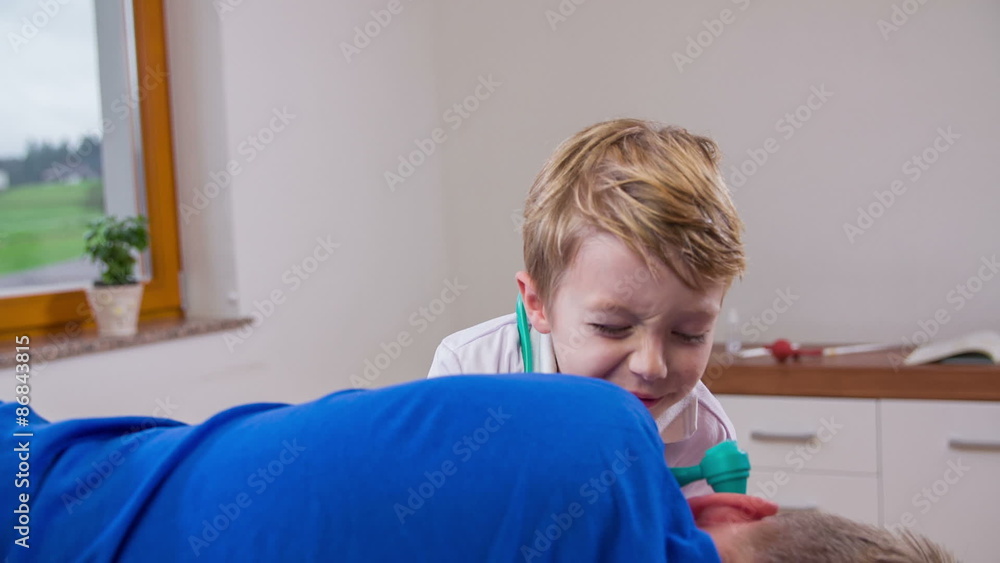 Young doctor using ear checker otoscope on patient Young doctor using ear checker otoscope on patient