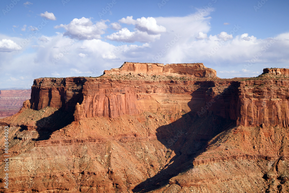 Fototapeta premium Schafer Canyon Majestic Buttes Puffy Clouds Blue Sky Canyonlands