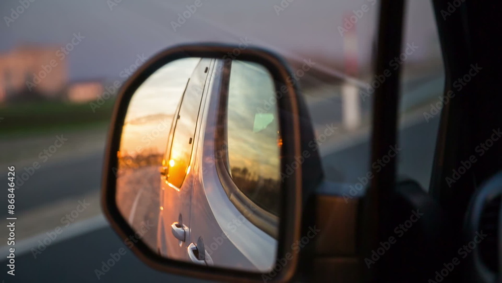 Sunset in car side mirror