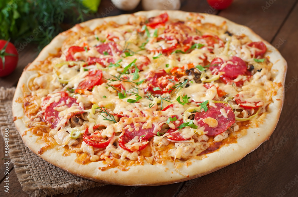 Pizza with salami, tomatoes and mushrooms