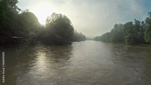 Sunrise and muddy river in slow motion photo