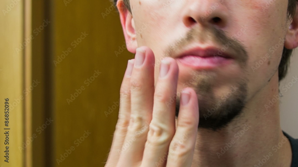 Male checking beard in close up Male checking beard in close up