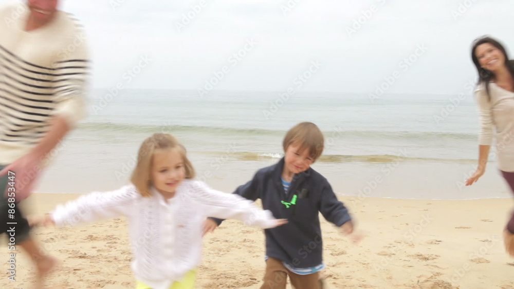 Family Playing On Fall Beach Together Family Playing On Fall Beach Together