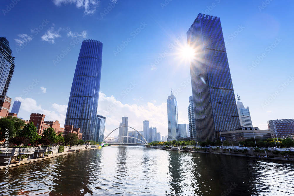 Obraz premium modern buildings in urban city at riverbank