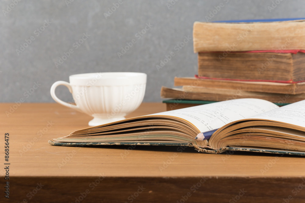 old book with pencil and coffee old book with pencil and coffee