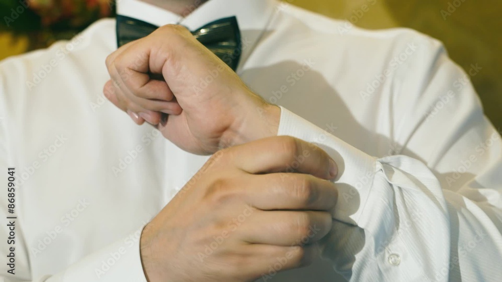 Man wears shiny cufflinks and watching the clock Man wears shiny cufflinks and watching the clock