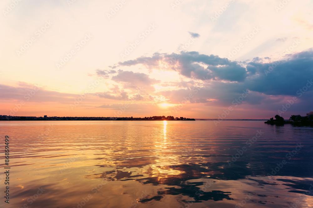 Retro Effect Of Summer Sunset With Beautiful Cloudy Sky Over Calm Sea Water