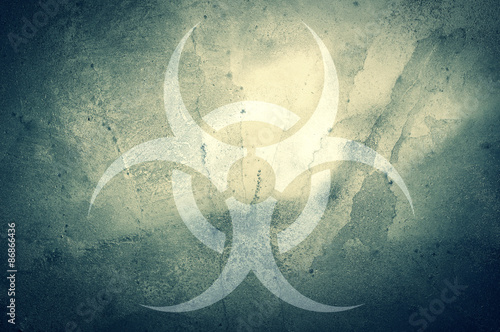A biohazard symbol on a grunge background.