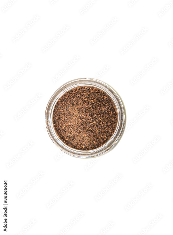 Dried processed tea leaves in a mason jar over white background Dried processed tea leaves in a mason jar over white background