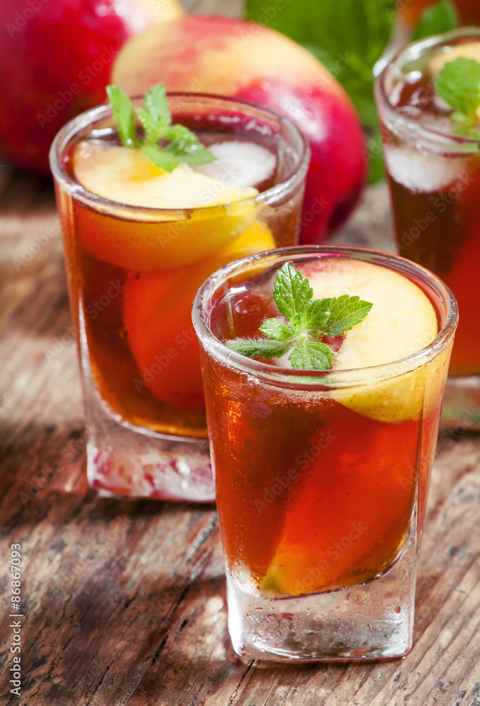 Peach Tea with pieces of fruit and mint on a wooden background, Peach Tea with pieces of fruit and mint on a wooden background,