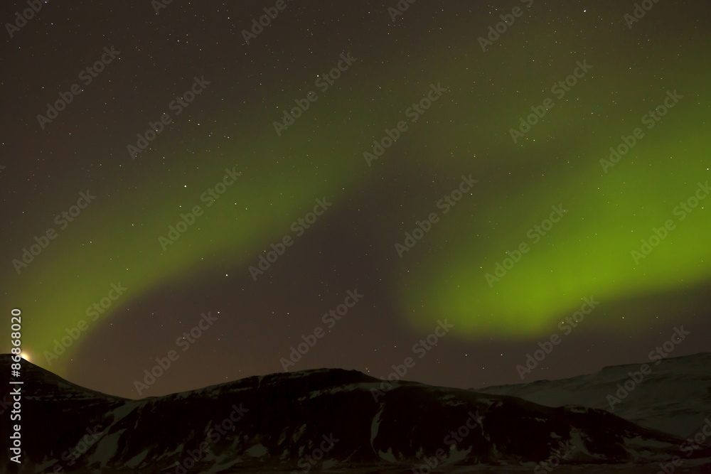 Northern lights with snowy mountains in the foreground