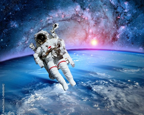 Fototapeta Naklejka Na Ścianę i Meble -  Astronaut spaceman outer space fantasy orbit planet earth sun. Elements of this image furnished by NASA.