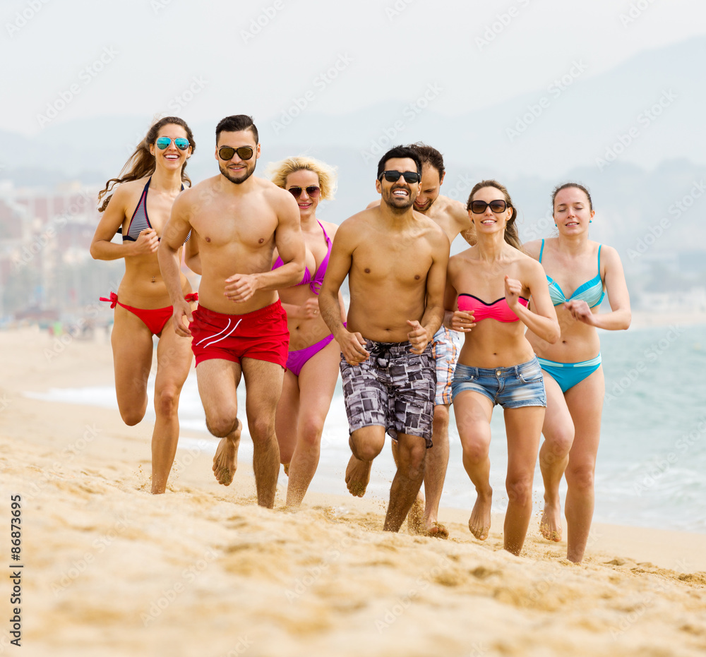 Happy people running at beach