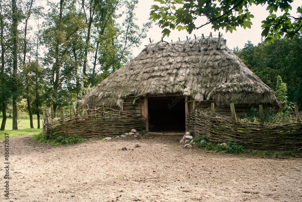 Old prehistoric barn or shack with straw roof